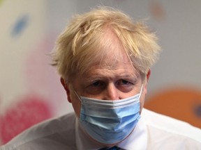 Prime Minister Boris Johnson wears a face mask as he visits Colchester hospital on May 27, 2021 in Colchester, United Kingdom.