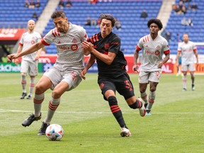 New York Red Bulls midfielder Caden Clark (right) battles for the ball against Toronto FC defender Omar Gonzalez during their game last week.