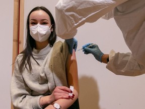 A young woman is vaccinated with the Pfizer-BioNTech vaccine at SZentrum on March 11, 2021 in Schwaz, Austria.