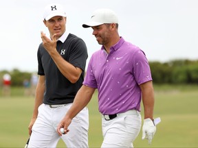 (L-R) Jordan Spieth of the United States walks with Paul Casey of England during a practice round prior to the 2021 PGA Championship at Kiawah Island Resort's Ocean Course on Wednesday.