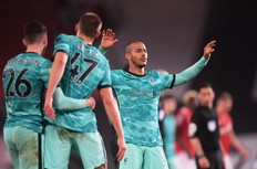 Liverpool's Thiago Alcantara (right), Andrew Robertson and Nathaniel Phillips celebrate after defeating Manchester United.