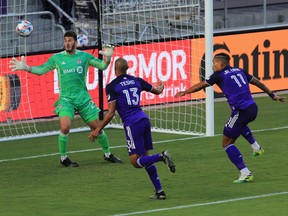Orlando City forward Tesho Akindele (13) scores a goal past Toronto FC goalkeeper Alex Bono on Saturday night.