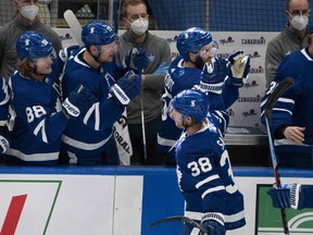 Toronto Maple Leafs defenceman Rasmus Sandin (38) celebrates with the bench after scoring a goal against the Montreal Canadiens on Saturday night.