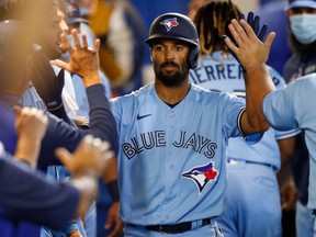 Blue Jays’ Marcus Semien, being congratulated by teammates after hitting one of his six home runs so far in 2021, says he can usually tell what kind of season he is going to have at the plate by his first 100 at-bats.