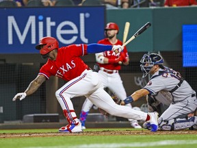 Texas Rangers outfielder Adolis Garcia hits a two-run double during the fourth inning against the Houston Astros at Globe Life Field.