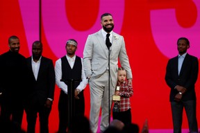 Drake, accompanied by his son Adonis, accepts the award for Artist of the Decade at the 2021 Billboard Music Awards outside the Microsoft Theater in Los Angeles, May 23, 2021.