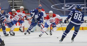 Canadiens’ Jake Evans skates the puck ahead of Maple Leafs’ Auston Matthews during Game 7. CLAUS ANDERSEN/GETTY IMAGES