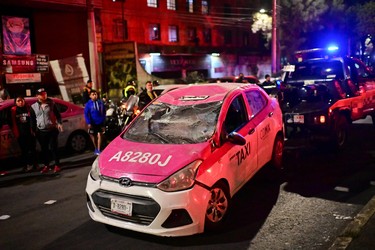 A tow truck removes a damaged taxi at the site of a train accident after an elevated metro line collapsed in Mexico City on May 4, 2021. (Photo by PEDRO PARDO/AFP via Getty Images)