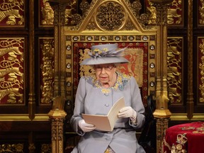Queen Elizabeth reads the Queen's Speech on the Sovereign's Throne in the House of Lords chamber during the State Opening of Parliament at the Houses of Parliament in London on May 11, 2021.