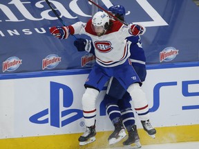 Montreal Canadiens forward Josh Anderson slams into Toronto Maple Leafs defenceman Justin Holl during a game on May 6.