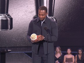 Anthony Mackie holds his Best Hero award for the movie The Falcon and the Winter Soldier during the 2021 MTV Movie & TV Awards in Los Angeles May 16, 2021.