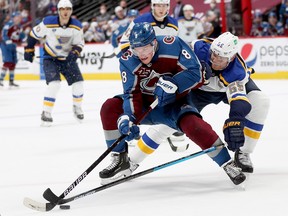 Cale Makar of the Colorado Avalanche fights for the puck against Colton Parayko of the St Louis Blues at the Ball Arena on May 19, 2021 in Denver.
