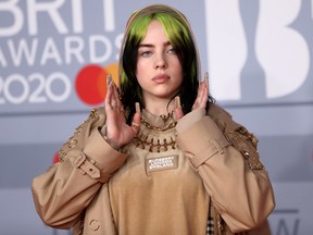 Billie Eilish poses as she arrives for the Brit Awards at the O2 Arena in London, February 18, 2020.
