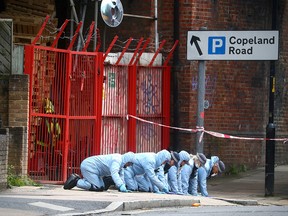 Forensic officers work at the area after Sasha Johnson, a Black Lives Matter activist, was shot in an early morning attack near her home in Peckham, London, May 24, 2021.