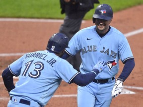 Toronto Blue Jays second baseman Joe Panik (right) celebrates his two-run home run with left fielder Lourdes Gurriel Jr. (13) during a game against the Cleveland Indians at Progressive Field.