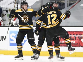 Bruins forward Craig Smith (12) reacts with teammates after scoring the game-winning goal in double overtime against the Capitals in Game 3 of the first round of the 2021 Stanley Cup Playoffs at TD Garden in Boston, Wednesday, May 19, 2021.