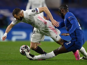 Chelsea defender Antonio Rudiger (right) tackles Real Madrid forward Karim Benzema during the UEFA Champions League second leg semifinal at Stamford Bridge in London on May 5, 2021.