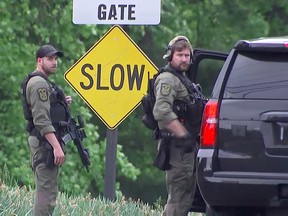 Law enforcement officers guard the entrance to the headquarters of the Central Intelligence Agency (CIA) after a security incident in Langley, Virginia, May 3, 2021 in a still image from video.
