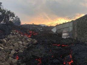 Smoldering ashes are seen early morning in Goma in the East of the Democratic Republic of Congo, Sunday, May 23, 2021, following the eruption of Mount Nyiragongo.