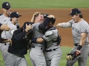 Yankees starting pitcher Corey Kluber (centre) is mobbed by teammates after throwing a no-hitter against the Rangers at Globe Life Field in Arlington, Texas, Wednesday, May 19, 2021.