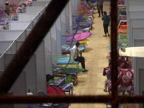 COVID-19 patients are seen inside the Common Wealth Games stadium temporarily converted into the COVID-19 coronavirus care centre in New Delhi on May 5, 2021.