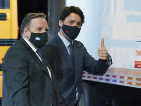 Prime Minister Justin Trudeau gives a thumbs up as he leaves a news conference accompanied by Quebec Premier Francois Legault in Montreal, on Monday, March 15, 2021.