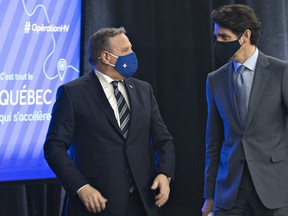 Quebec Premier Francois Legault, left and Prime Minister Justin Trudeau chat after they announced high speed internet for Quebec regions, Monday, March 22, 2021 in Trois-Rivieres Que.