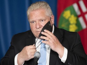 Ontario Premier Doug Ford reacts to a question during a press conference at the legislature in Toronto, Thursday, May 13, 2021.