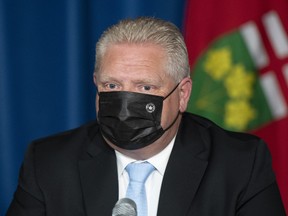 Ontario Premier Doug Ford listens to a question during a press conference at the Ontario legislature in Toronto, Thursday, May 13, 2021.