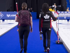 Canada skip Kerri Einarson (right) and third Val Sweeting walk off the ice after losing to Sweden Saturday at the World Women’s Curling Championship in Calgary.