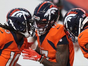 DaeSean Hamilton, centre, of the Denver Broncos celebrates his touchdown with teammates Jerry Jeudy, left, and KJ Hamler as they take on the Los Angeles Chargers in the fourth quarter of the game at Empower Field At Mile High on Nov. 1, 2020 in Denver, Col.