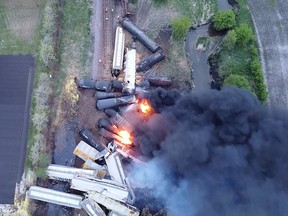 Fire is seen on a Union Pacific train carrying hazardous material that has derailed in Sibley, Iowa, in this still frame obtained from social media drone video dated May 16, 2021.