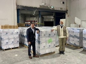 Dr. Steve Gupta (left) and Dr. Budhen Doobay (right) are seen in Toronto with oxygen cencentrators bound for COVID-ravaged India.