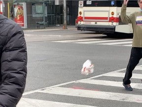 An interaction between two men at Yonge and College Sts. in Toronto on Sunday, May 9, 2021.