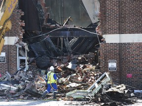 Workers tear down the exterior wall after Toronto Fire battled a 6-alarm blaze at York Memorial Collegiate Institute in the Keele and Eglinton West area. Wednesday May 8, 2019.