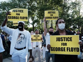 People gather for a memorial rally and march in Brooklyn in honour of George Floyd on the one year anniversary of his death on May 25, 2021.