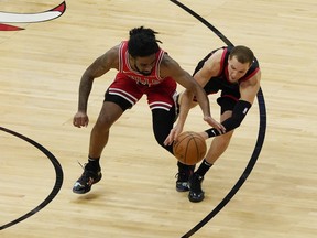Raptors' Malachi Flynn (right) and Bulls' Coby White battle for a loose ball during the second half at United Center in Chicago on Thursday, May 13, 2021.