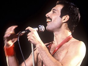 Freddie Mercury performing with Queen.