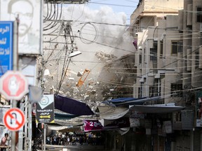 Debris flies as smoke rises following an Israeli air strike, amid Israeli-Palestinian fighting, in Khan Younis in the southern Gaza Strip, May 20, 2021.