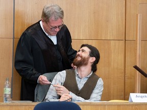 Lawyer Johannes Hock talks to defendant Franco A. at a regional court in Frankfurt, Germany, May 20, 2021.