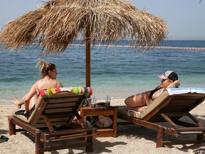 People enjoy the sun during the official reopening of beaches to the public, following the easing of measures against the spread of the coronavirus disease in Athens, Greece, May 8, 2021.