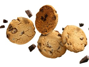 Flying Chocolate chip cookies with pieces of chocolate isolated on white background. High resolution image.