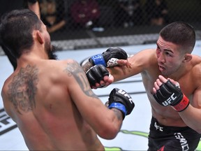 In this UFC handout, Louis Smolka, right, punches Jose Quinonez of Mexico in a bantamweight bout during the UFC Fight Night event at UFC APEX on Dec. 5, 2020 in Las Vegas, Nevada.