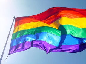 A rainbow flag is waving in the wind.