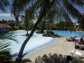 Tourists sunbathe near a pool in a hotel, as Costa Rica tourism industry braces for coronavirus disease (COVID-19) outbreak, in Heredia, Costa Rica March 18, 2020.