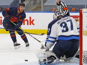 Edmonton Oilers forward Connor McDavid (97) puts a shot just wide of Winnipeg Jets goaltender Connor Hellebuyck (37) during the third period in game one of the first round of the 2021 Stanley Cup Playoffs at Rogers Place May 19, 2021