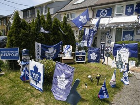 While there won't be any spectators at Scotiabank Arena, Sara Adamson, owner of a home on Merton St., shows her support for the Maple Leafs with exterior decorations.