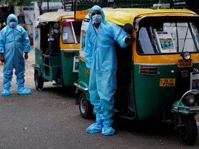 Drivers stand near auto rickshaw ambulances, prepared to transfer people suffering from COVID-19 and their relatives for free, in New Delhi, India May 5, 2021.