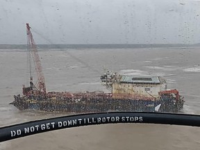 In this handout photo taken on May 18, 2021 and released by the Indian Coast Guard, the offshore barge GAL Constructor is seen from a Chetak helicopter off the Satpati coast, after Cyclone Tauktae hit the west coast of India with powerful winds and driving rain, leaving at least 20 people dead.