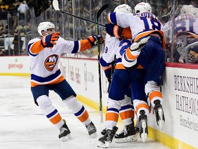 The New York Islanders celebrate the game winning goal by Josh Bailey during the second overtime period against the Pittsburgh Penguins at PPG PAINTS Arena on May 24, 2021 in Pittsburgh.